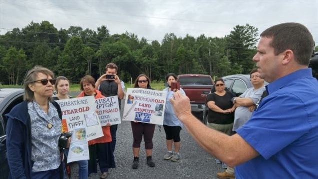 Mohawk leader Ellen Gabriel, far left, listens to Oka Mayor Pascal Quevillon during a protest Wednesday at the site of the Collines D’Oka housing developmen