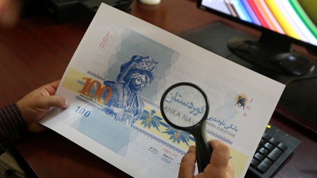 Aso Mamzada, a Kurdish designer, who designed the Kurdish currency, uses a magnifying glass as he works his office in Arbil, the capital of the autonomous Kurdish region of northern Iraq, on June 17, 2017. Iraq’s autonomous Kurdish region will hold a historic referendum on statehood in September, despite opposition to independence from Baghdad and possibly beyond.