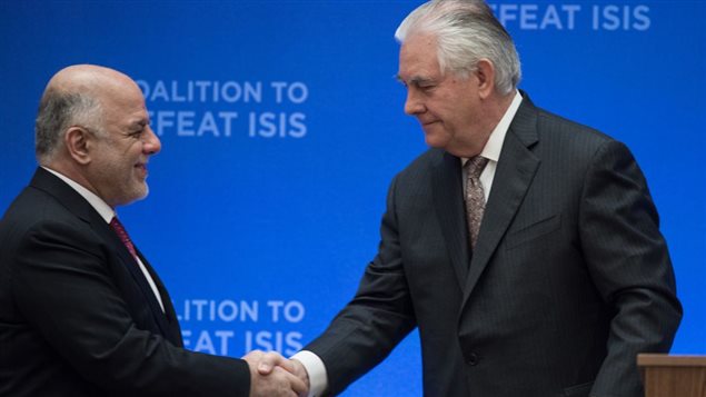 US Secretary of State Rex Tillerson (R) shakes hands with Iraqi Prime Minister Haidar al-Abadi during the opening of a meeting of the coalition to defeat the Islamic State group at the State Department in Washington, DC, on March 22, 2017.