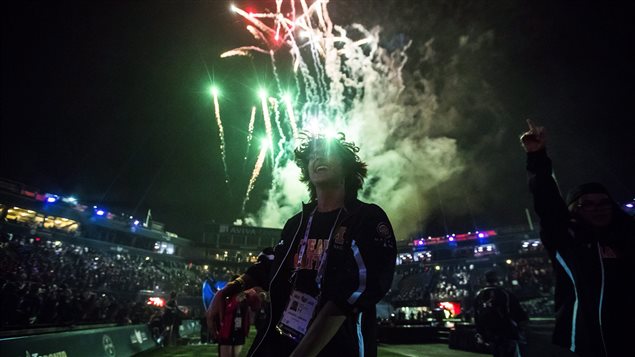 An athlete from Manitoba celebrates as fireworks go off during the opening ceremony of the 2017 North American Indigenous Games, in Toronto on Sunday, July 16, 2017. 