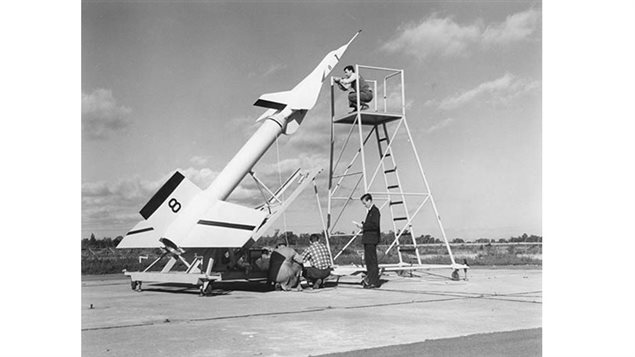 One of the Arrow test models atop the launch rocket showing relative size.