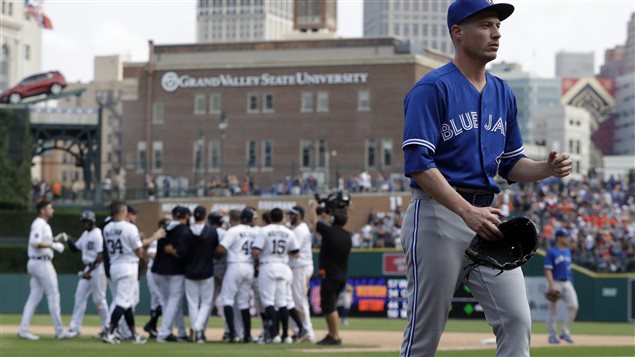 Blue Jays relief pitcher Lucas Harrell, foreground, walks off the field as the Detroit Tigers celebrate their win in the 11th inning Sunday in Detroit. It's been that kind of season for the Jays.