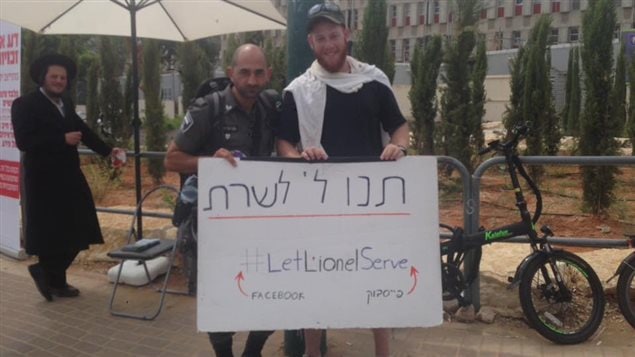 Lionel with his sign in Israel, "let Lionel join"
