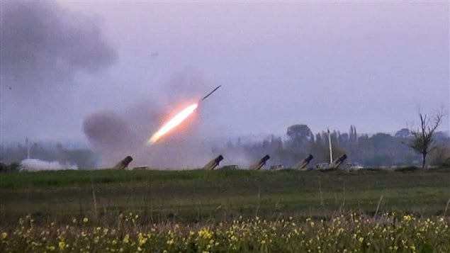 In this image made from video on Sunday, April 3, 2016, a Grad missile is fired by Azerbaijani forces in the village of Gapanli, Azerbaijan. 