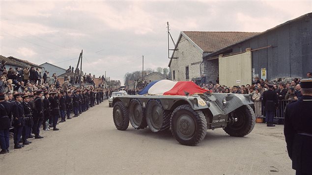 Crowds lined up on the street watch as the tricolor covered coffin of former French President General Charles de Gaulle (1890-1970) is carried on an armoured vehicle to the cemetery of Colombey-les-Deux-Eglises in Haute-Marne, France, November 12, 1970. It took Canadian officials several drafts to come up with an official letter of condolences, says former Canadian diplomat Ferry de Kerchove.