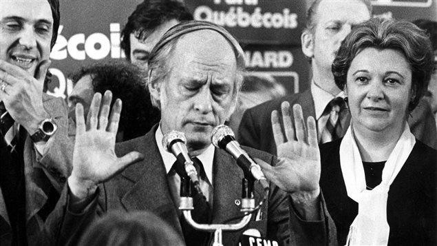 FILE--Quebec Premier Rene Levesque tries to hush supporters at a Parti Quebecois rally in Montreal, Nov.15, 1976, following his party’s victory over the Liberal party of Robert Bourassa in the provincial election. 