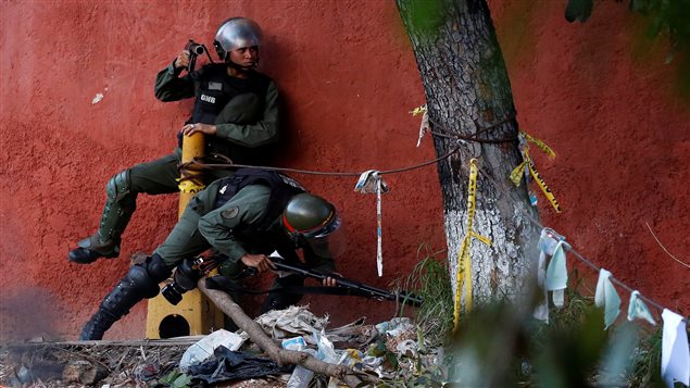 Riot security forces pass through a roadblock during a strike called to protest against Venezuelan President Nicolas Maduro’s government in Caracas, Venezuela July 26, 2017.