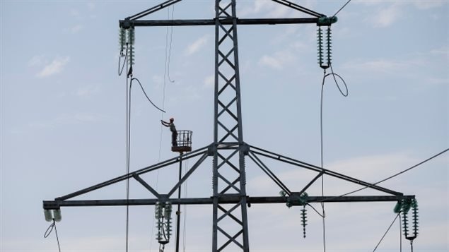 A worker repaired a high voltage line in Ukraine in 2014 after a cyberattack on the power grid.