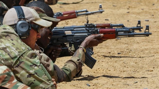 A member of Canadian Special Operations Forces Command coaches a member of the Niger Armed Forces during marksmanship training as part of Exercise Flintlock 2017 in Diffa, Niger, Feb. 28, 2017. Flintlock is a special operations forces exercise designed to hone the capabilities of U.S. and partner nation military units in Trans-Saharan Africa. (U.S. Army photo by Sgt. 1st Class Christopher Klutts)