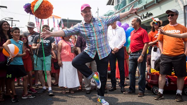 British Columbia Premier John Horgan cavorted in rainbow sneakers before joining the parade.