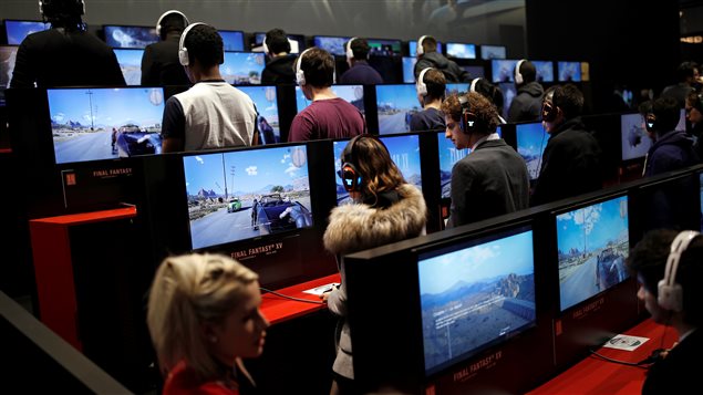 Visitors play the video game Final Fantasy XV at the Paris Games Week, a trade fair for video games in Paris, France, October 26, 2016. 