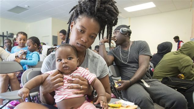 Asylum seekers wait to be processed at the Canada Border Services Agency office in Lacolle, Que., Friday, August 4, 2017.