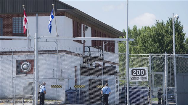 Guards stand outside of an immigrant holding centre in Laval, Quebec.