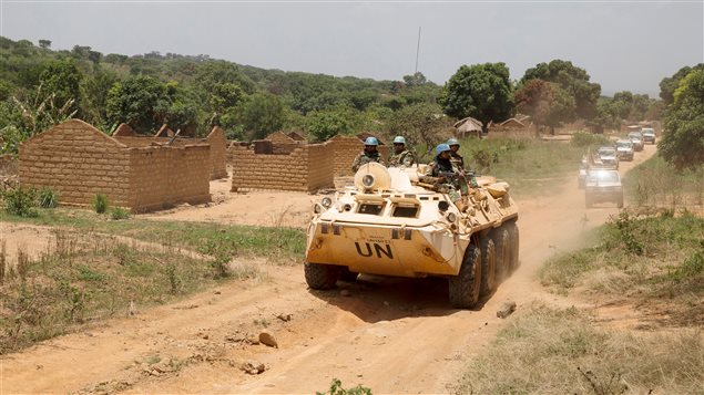 United Nations peacekeeping force vehicles drive by houses destroyed by violence in September, in the abandoned village of Yade, Central African Republic April 27, 2017.