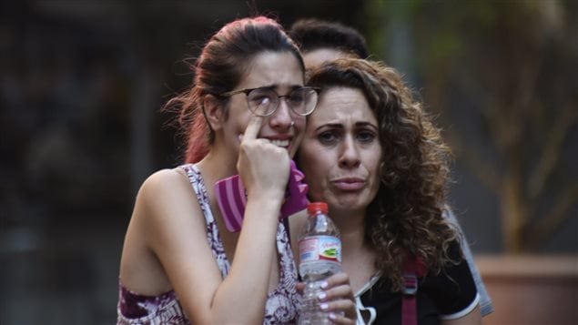 People flee from the scene after a white van jumped the sidewalk in the historic Las Ramblas district of Barcelona, Spain, crashing into a summer crowd of residents and tourists Thursday, Aug. 17, 2017. According to witnesses the white van swerved from side to side as it plowed into tourists and residents.