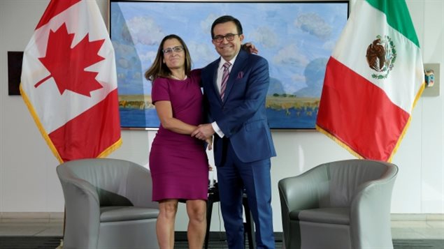 Freeland poses with Mexican Secretary of Economy Ildefonso Guajardo Villarreal before the first round of NAFTA talks. 