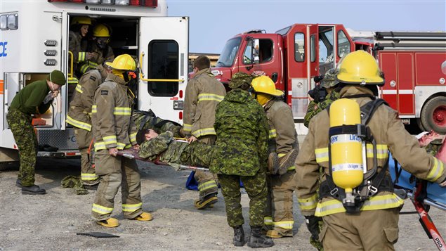 Firefighters from Rankin Inlet, NU assist a simulated casualty on August 22, 2017 during a scenario on Operation NANOOK to test the whole of government response to an emergency in Canada’s North.