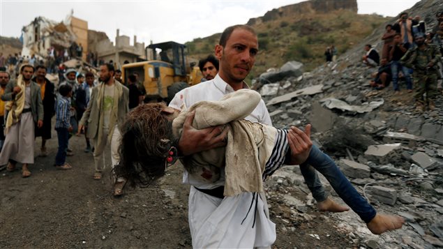 A man carries the body of a girl recovered from the site of a Saudi-led air strike in Sanaa, Yemen August 25, 2017.