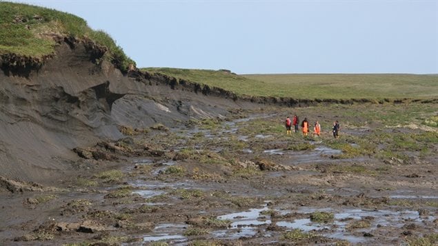 Retrogressive thaw slump.High ground is permafrost and soil, slump is the soil only -whatls left without ice (water) content and support