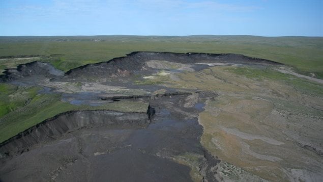 Aerial view of ground ice thaw on Herschel Island. the island has a high percentage of ice supporting a lesser level of soil. When it thaws the water drains away leaving a a relatively small amount of soil.