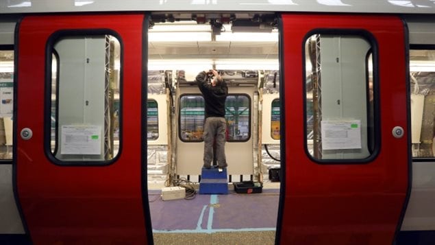 A Bombardier employee in Derby, England works on a subway car for the London underground.