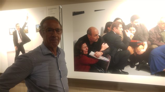 Burhan Özbilici frente a sus fotos en la exposición del World Press Photo de Montreal.