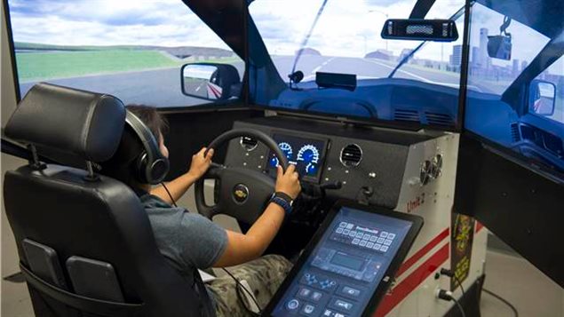 A participant of the Women in Force program tries out the driving simulator at the Canadian Forces Military Police Academy (CFMPA) Canadian Forces Base (CFB) Borden, Ontario on August 16, 2017.