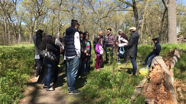 Volunteers and guides show Syrian refugees around Toronto’s High Park Nature Centre.