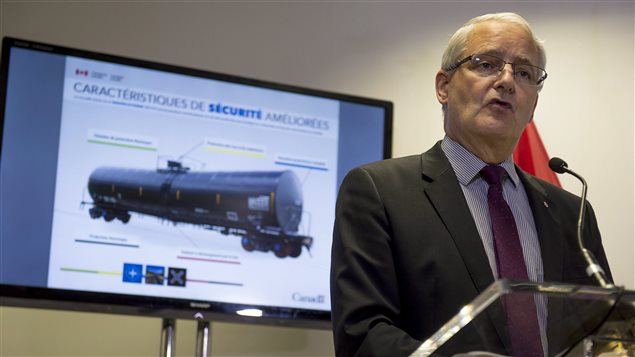 Federal Transport Minister Marc Garneau makes an announcement in Montreal on Monday, July 25, 2016. Garneau confirmed older DOT-111 rail tanker cars will not be able to transport crude oil or other dangerous goods as of Nov. 1. The cars are the same model that was involved in the deadly Lac-Megantic tragedy in which 47 people died three years ago. The ban kicks in on Nov. 1, six months earlier than planned for *non-jacketed* cars.