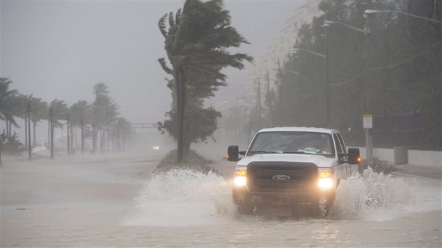 A truck rolls through a flooded street on the waterfront of Fort Lauderdale as Hurricane Irma blows in Sunday, September 10, 2017. 