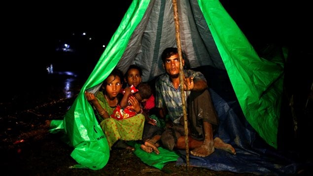 Rohingya refugees sit inside a makeshift tent near Gundum in Cox’s Bazar, Bangladesh, September 3, 2017.