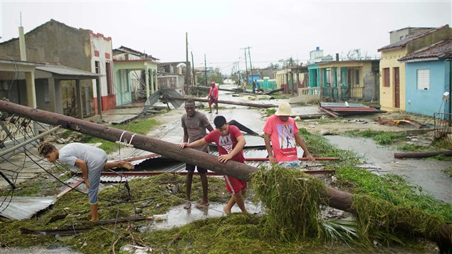 People walk on a damaged street after the passage of Hurricane Irma in Caibarien, Cuba, September 9, 2017.