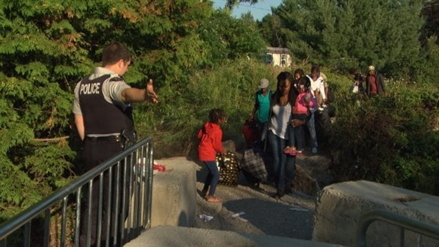 Asylum seekers cross into Quebec earlier this year. Canadian officials believe as many as 40,000 people will be seeking refuge before the end of 2017.