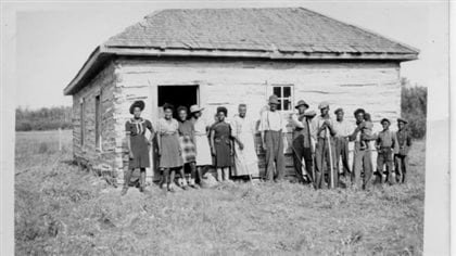 Three generations of the Mayes family in front of the Shiloh Baptist Church they built in Eldon District, North of Maidstone, Saskatchewan.