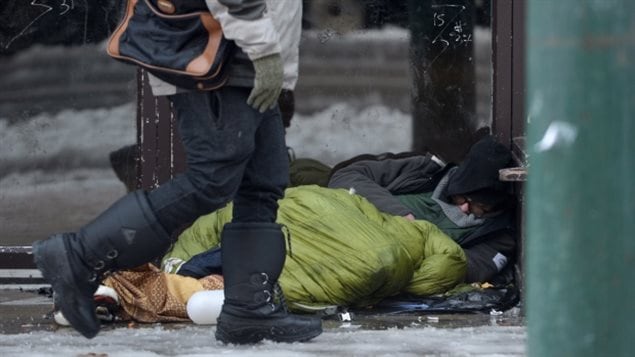 A homeless man sleeps in a doorway in Vancouver's Downtown Eastside last December. The number of homeless people in the metro Vancouver area continues to grow--mainly because of housing costs and lack of income. 