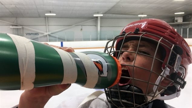 Joey Kapel, nine, consumes sports drink at a hockey rink in Toronto. 