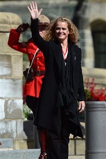 New Governor General Julie Payette waves to onlookers as she receives a salute from an RCMP officer following her installation ceremony in the Senate chamber in Ottawa on Monday. 