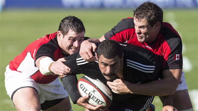 New Zealand Maori All Black's Ben Afeaki (centre) breaks past Canada's Aaron Carpenter (left) and Tyler Ardron during first half rugby action in Toronto in 2013. Sports columnist Bruce Dowbiggin says adopting rugby's tackling rules would go a long way to solving the injury problems plaguing North American football.