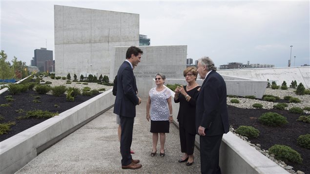 Prime Minister Justin Trudeau speaks with holocaust survivors Eva Kuper, Georgette Brinberg and Philip Goldig before dedicating the National Holocaust Monument in Ottawa last Wednesday. 