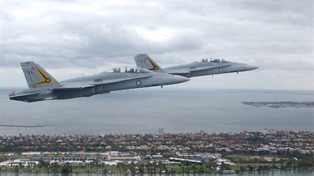 Royal Australian Air Force FA-18 Hornets fly over Melbourne in 2002. Canada is considering buying the used aircraft, but because the U.S.-built fighters are classified as advanced warplanes. the Trump administration would have to sign off on the sale.