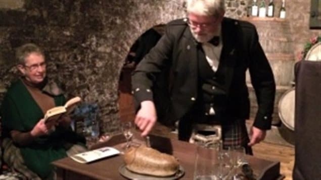 David Allison of the St. Andrew’s Society in St John’s Newfoundland cuts the haggis at a Robbie Burns celebration in 2015