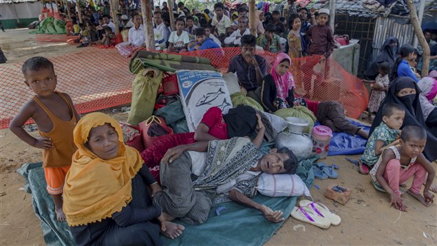 Rohingya Muslims who crossed from Myanmar into Bangladesh rest inside a roadside shelter on Oct. 23, 2017.