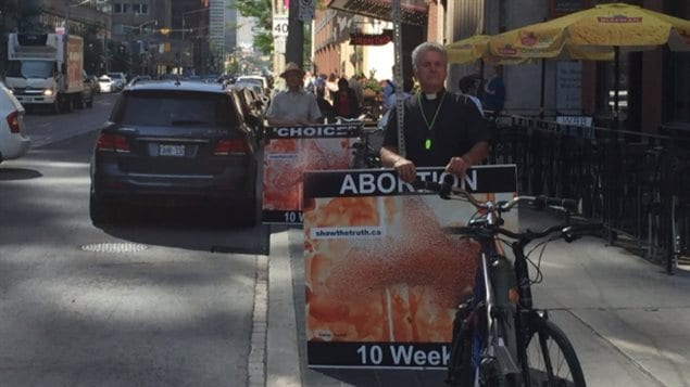 Members of the Canadian Centre for Bio-Ethical Reform demonstrate against abortion on College Street  in downtown Toronto in July using large graphic signs. 