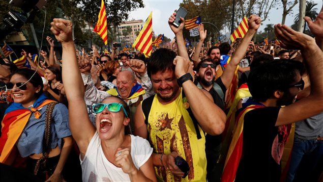 People celebrate after the Catalan regional parliament declares the independence from Spain in Barcelona.