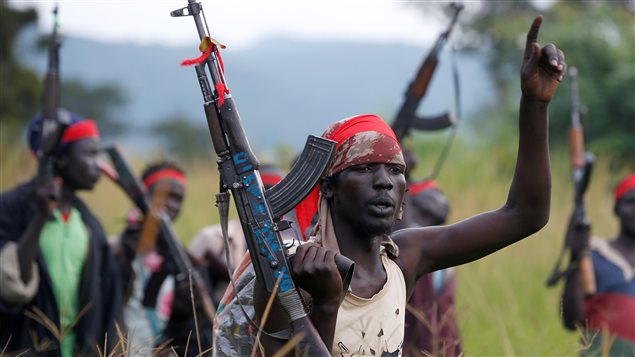 SPLA-IO (SPLA-In Opposition) rebels hold up guns in Yondu, the day before an assault on government SPLA (Sudan People’s Liberation Army) soldiers in the town of Kaya, on the border with Uganda, South Sudan, August 25, 2017.