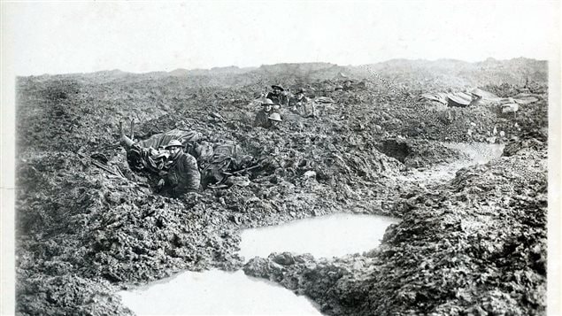 Troops of the Canadian 16th Machine Gun Company hold the line in atrocious conditions on the Passchendaele front in late October or early November, 1917 The machine-gunner closest to the camera is Private Reginald Le Brun, the only one in the photo to survive.