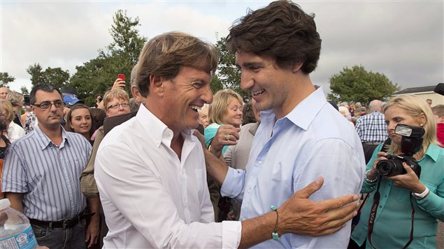 Liberal leader Justin Trudeau, right, chats with Stephen Bronfman, the party’s chief fundraiser, at a barn party in St. Peters Bay, P.E.I. on Wednesday, Aug. 28, 2013.