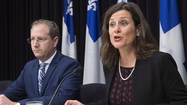 Quebec Justice Minister Stephanie Vallee provides further details about how the government’s controversial Bill 62 will be implemented at the legislature, as Justice Minister Yan Paquette, left, looks on in Quebec City Tuesday, October 24, 2017. The law bans people from giving or receiving public services if their face is covered.