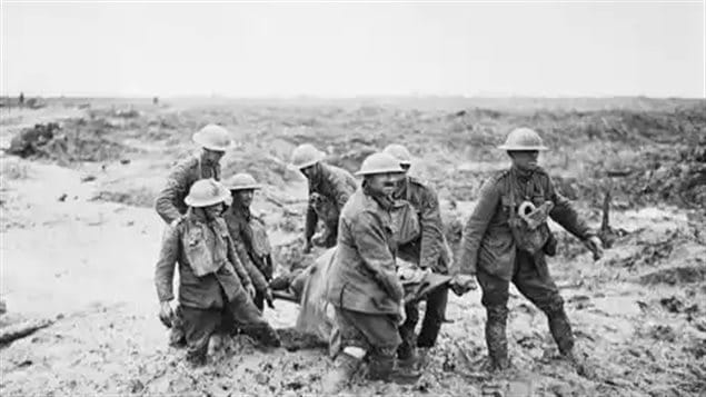 A strecther party struggles through knee deep mud at Passchendaele