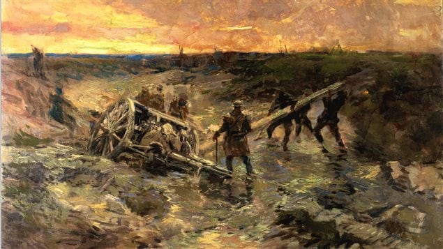 Canadian gunners struggle to free an 18pdr field gun which has sunk into mud
